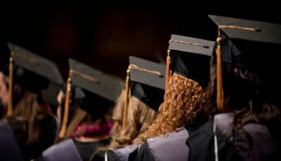 Graduates looking forward while they wait in line to begin ceremony
