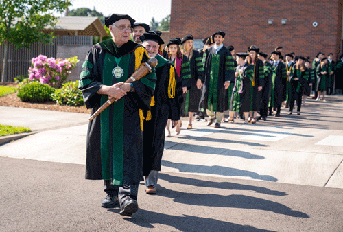 Dr. Cundari leading the COMP-Northwest graduates into the ceremony
